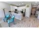 Bright kitchen featuring white cabinets, modern stainless steel appliances, and stylish light-tone flooring at 9660 Sweetwell Pl, Riverview, FL 33569