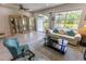 Bright living room with tile flooring, large windows, and sliding glass doors to the patio at 9660 Sweetwell Pl, Riverview, FL 33569