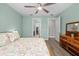 Primary bedroom featuring light blue walls, hardwood floors and natural light at 9921 Pier Point Ter, Parrish, FL 34219