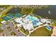 Aerial view of community clubhouse featuring tennis courts, pool, and surrounding ponds at 9921 Pier Point Ter, Parrish, FL 34219