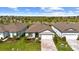 Aerial front view of a single-story home with a paver driveway and well-maintained front yard landscaping at 9921 Pier Point Ter, Parrish, FL 34219