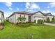Charming single-story home featuring a well-manicured lawn, complemented by colorful landscaping and a two-car garage at 9921 Pier Point Ter, Parrish, FL 34219