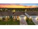 Charming single-Gathering home with lush landscaping, brick driveway, and a well-manicured lawn at sunset at 9921 Pier Point Ter, Parrish, FL 34219
