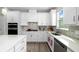 Well-appointed kitchen features sleek countertops, backsplash, and updated appliances, with wood flooring at 9921 Pier Point Ter, Parrish, FL 34219