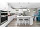 Modern kitchen with white cabinetry, stainless steel appliances, hardwood floors, and a center island at 9921 Pier Point Ter, Parrish, FL 34219