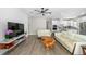 Open floorplan with hard surface flooring and large couch; bright white kitchen at 9921 Pier Point Ter, Parrish, FL 34219