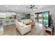 Bright open living area with view to kitchen, dining space, and screened patio leading to pool area at 9921 Pier Point Ter, Parrish, FL 34219