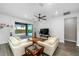 Bright living room featuring hard surface flooring, fan and sliding glass door to patio at 9921 Pier Point Ter, Parrish, FL 34219