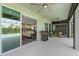 Screened-in patio with ceiling fans, lounge chairs, and view of the outdoor pool at 9921 Pier Point Ter, Parrish, FL 34219
