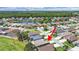 Aerial view of neighborhood featuring a pond, mature trees, and proximity to community ballfields at 2452 Big Pine Dr, Holiday, FL 34691