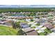 Aerial view of neighborhood featuring a pond, mature trees, and proximity to community ballfields at 2452 Big Pine Dr, Holiday, FL 34691