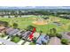 Aerial view of the property featuring solar panels and a location adjacent to community ballfields at 2452 Big Pine Dr, Holiday, FL 34691