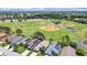 An aerial view highlighting the proximity of the home to a baseball field and featuring solar panels on nearby houses at 2452 Big Pine Dr, Holiday, FL 34691