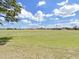 Expansive green backyard with a view of the community sports field, perfect for recreation at 2452 Big Pine Dr, Holiday, FL 34691