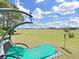 Relaxing backyard swing overlooking a well-maintained green lawn and community baseball field at 2452 Big Pine Dr, Holiday, FL 34691