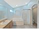 Inviting bathroom features a soaking tub, glass-enclosed shower, and modern fixtures at 2452 Big Pine Dr, Holiday, FL 34691
