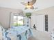 Cozy bedroom features a ceiling fan, plenty of natural light, and carpeted floor at 2452 Big Pine Dr, Holiday, FL 34691