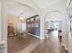 Bright dining room with hardwood floors, chandelier, and a view into the open-concept kitchen and living areas at 2452 Big Pine Dr, Holiday, FL 34691