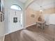 A bright foyer with hardwood flooring leads into a dining area with chandelier at 2452 Big Pine Dr, Holiday, FL 34691
