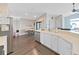 Spacious eat-in kitchen featuring white cabinets, hardwood floors, and easy access to breakfast nook and living area at 2452 Big Pine Dr, Holiday, FL 34691