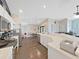 Bright, open kitchen with stainless steel appliances and a view to dining and living areas at 2452 Big Pine Dr, Holiday, FL 34691