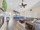 Spacious living room with hardwood floors, vaulted ceiling, and open layout to the kitchen and dining areas at 2452 Big Pine Dr, Holiday, FL 34691
