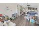 Open-concept living room showing fireplace, hardwood floors, and a view into the adjacent kitchen and dining area at 2452 Big Pine Dr, Holiday, FL 34691