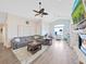 Cozy living room with a fireplace, hardwood floors, vaulted ceilings, and ample natural light at 2452 Big Pine Dr, Holiday, FL 34691