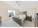 Serene main bedroom showcasing neutral tones, large windows, and comfortable furnishings at 2452 Big Pine Dr, Holiday, FL 34691