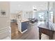 Open-concept layout with hardwood flooring, seamlessly connecting the kitchen, dining, and living areas at 2452 Big Pine Dr, Holiday, FL 34691