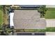 Aerial view of a home's roof featuring a screened-in lanai, landscaping, and an expansive driveway at 2452 Big Pine Dr, Holiday, FL 34691