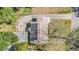 A birdseye aerial view of the home with a dark brown roof with solar panels at 1025 W Berry Ave, Tampa, FL 33603