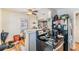 Kitchen featuring a breakfast bar, black appliances, and wood-look flooring at 1025 W Berry Ave, Tampa, FL 33603