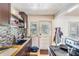 The kitchen features a decorative backsplash, laminate counters, and access to the backyard at 1025 W Berry Ave, Tampa, FL 33603