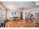 Open-concept living and dining area with ceiling fans and attractive wood floors at 1025 W Berry Ave, Tampa, FL 33603