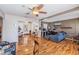 Open-concept living room flows seamlessly, featuring beautiful wood floors and a ceiling fan at 1025 W Berry Ave, Tampa, FL 33603