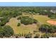 Aerial view showcases a large community park with baseball field, walking path, and scattered trees at 10314 Lake Carroll Way, Tampa, FL 33618