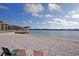Beach area with chairs, picnic tables, and access to the lake perfect for relaxing and enjoying the view at 10314 Lake Carroll Way, Tampa, FL 33618