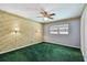 Bedroom features decorative wallpaper, wall-mounted sconces, and a view of the neighborhood at 10314 Lake Carroll Way, Tampa, FL 33618