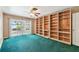 Bedroom featuring sliding doors to the back yard and a large built-in bookcase at 10314 Lake Carroll Way, Tampa, FL 33618