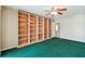Bedroom featuring a large built-in bookcase and green carpet at 10314 Lake Carroll Way, Tampa, FL 33618
