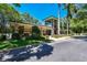 Exterior shot of a well-maintained clubhouse with brick accents, manicured landscaping, and ample parking at 10314 Lake Carroll Way, Tampa, FL 33618
