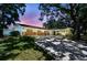 Inviting single-story home showcasing a brick facade, a convenient carport, and a mature tree-lined yard at 10314 Lake Carroll Way, Tampa, FL 33618