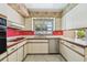 Functional kitchen featuring stainless steel appliances, tile floors, and abundant counter space at 10314 Lake Carroll Way, Tampa, FL 33618