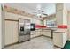 Charming kitchen with stainless steel appliances, decorative wallpaper, tile floors and ample counter space at 10314 Lake Carroll Way, Tampa, FL 33618