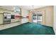 Open kitchen and dining room with stainless steel appliances, tile floors, and view of the backyard at 10314 Lake Carroll Way, Tampa, FL 33618