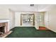 The living room showcases a brick fireplace, green carpet, and an entryway with built-in shelving at 10314 Lake Carroll Way, Tampa, FL 33618