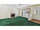 Inviting living room boasts a traditional brick fireplace, bright windows, and a warm, welcoming atmosphere at 10314 Lake Carroll Way, Tampa, FL 33618