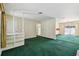 Open living room with a built-in bookcase and view into another room with sliding glass doors at 10314 Lake Carroll Way, Tampa, FL 33618