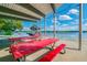 Lakeside picnic area with tables and a covered shelter, perfect for outdoor gatherings and enjoying scenic views at 10314 Lake Carroll Way, Tampa, FL 33618